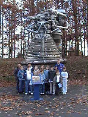 The group infront of an engine.